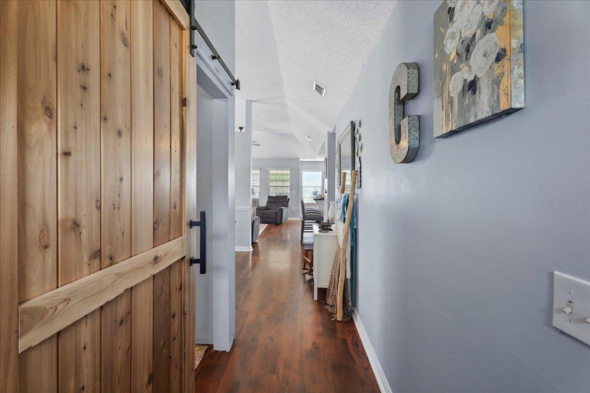 536 Moultrie Wells Road St. Augustine, FL 32086 - Photo 5 of 40 a view of a hallway with wooden floor and staircase