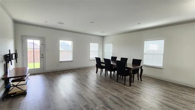 a view of a dining room with furniture and wooden floor