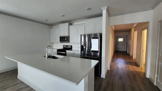 a view of a dining room with furniture and chandelier