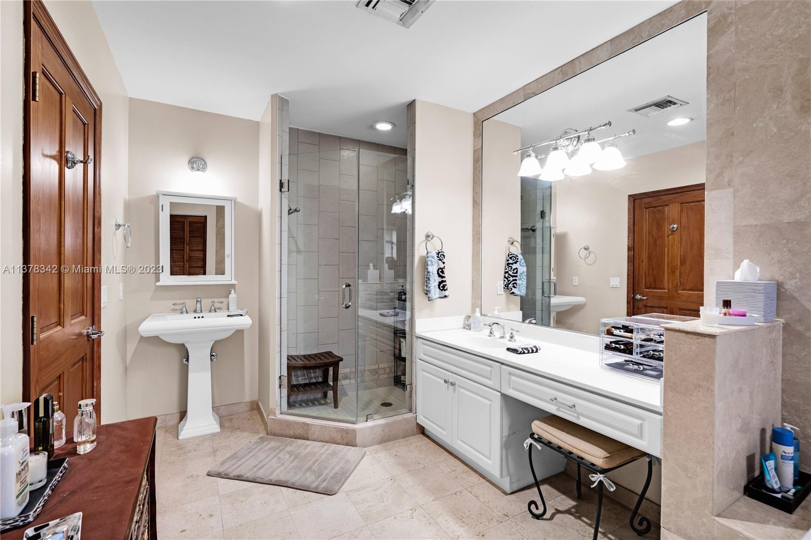 428 Southwest 19th Road Miami, FL 33129 - Photo 27 of 38 a bathroom with a double vanity sink a mirror and a shower