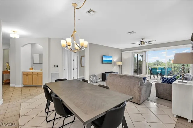a view of a dining room with furniture and a chandelier