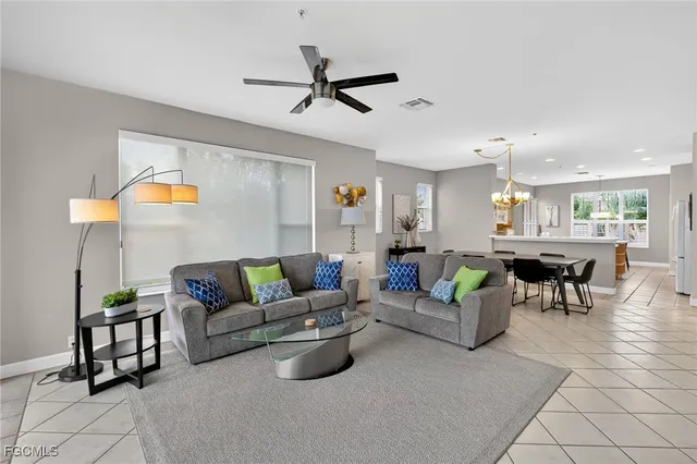 a living room with furniture and kitchen view