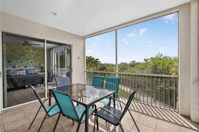 a view of a balcony with table and chairs