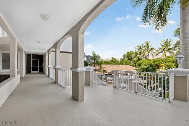 a view of a patio with wooden floor and iron fence