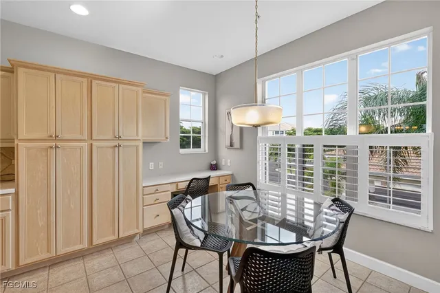 a table and chairs in a room next to a window