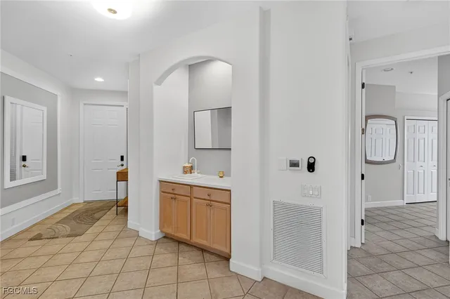 a spacious bathroom with a shower a sink and a mirror