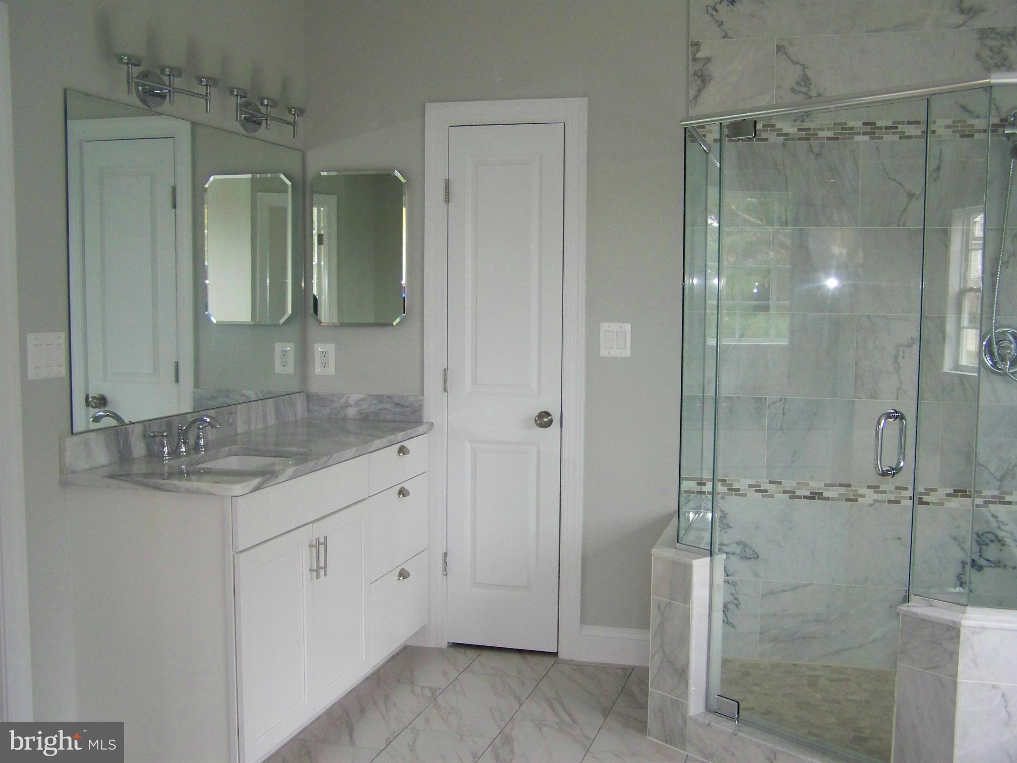 4324 Holly Ridge Road Rockville, MD 20853 - Photo 12 of 16 a bathroom with a granite countertop sink mirror and shower