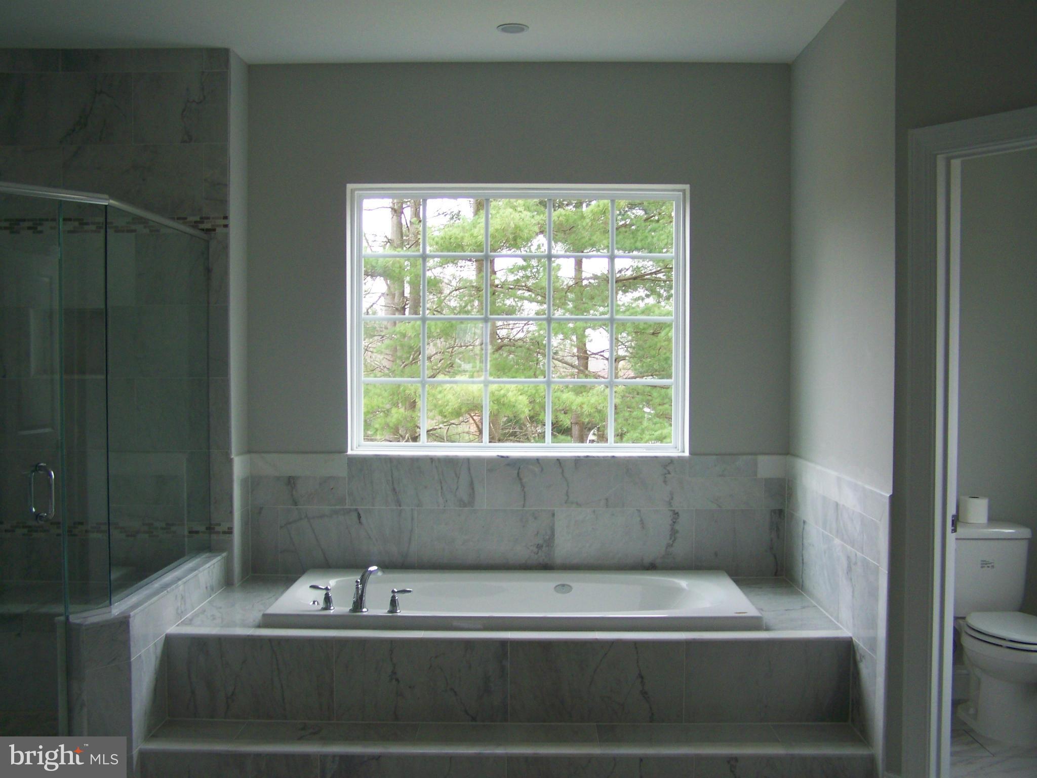 4324 Holly Ridge Road Rockville, MD 20853 - Photo 10 of 16 a bathroom with a bathtub and window