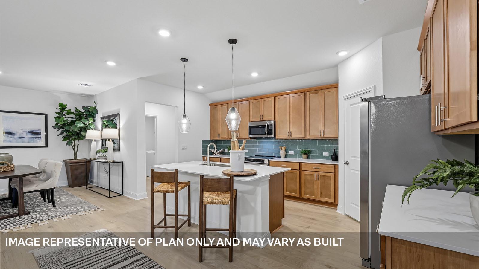 244 Rivers Edge Drive Georgetown, TX 78628 - Photo 14 of 37 a kitchen with stainless steel appliances kitchen island granite countertop a refrigerator a stove a sink a dining table and chairs with wooden floor