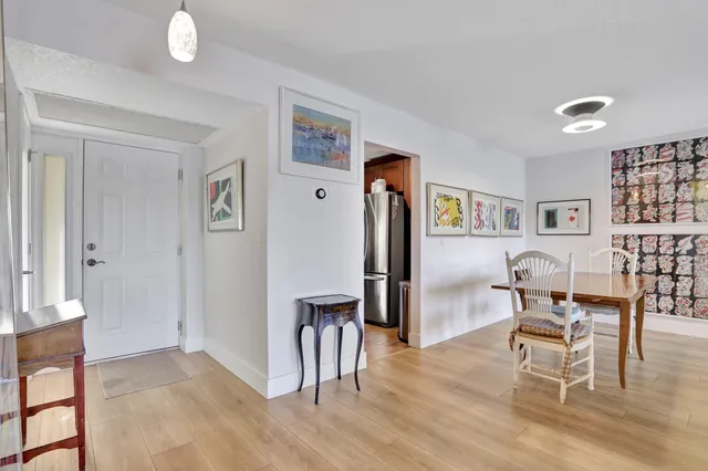 a dining room with furniture and wooden floor