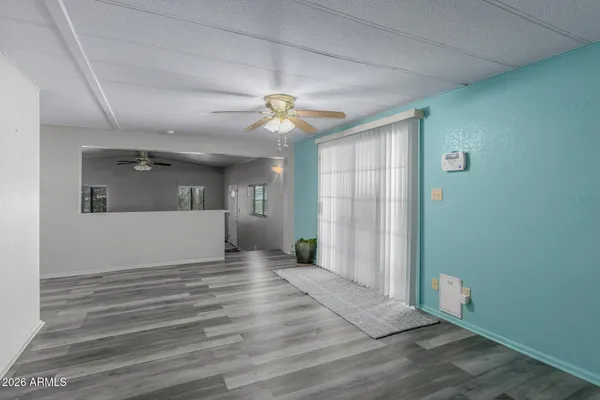 a view of a hallway with wooden floor and a window