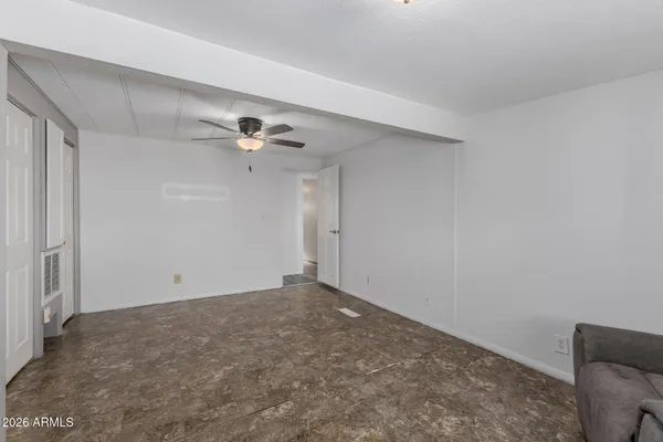 a view of an empty room with a ceiling fan