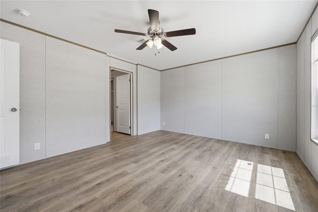 150 19th Street Interlachen, FL 32148 - Photo 15 of 30 an empty room with wooden floor and windows