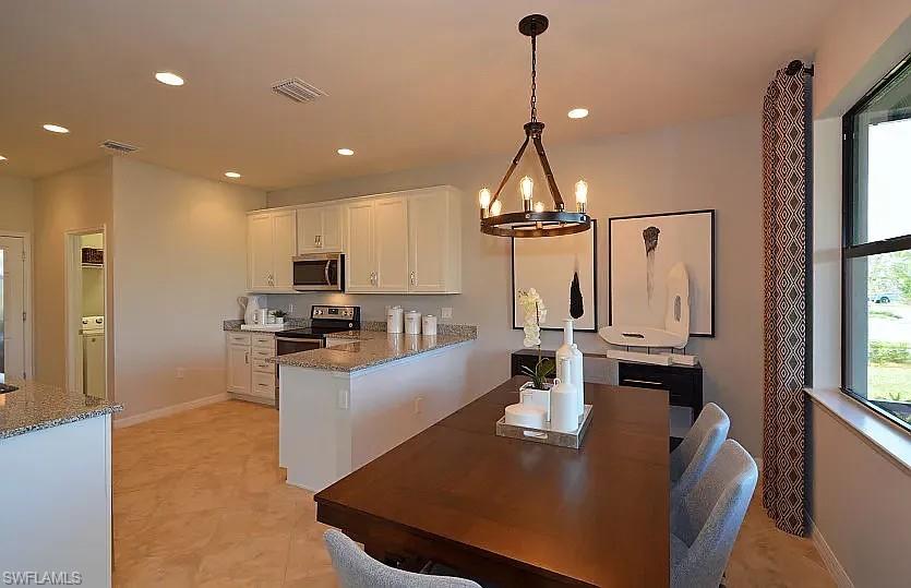 4085 Spotted Eagle Way Fort Myers, FL 33966 - Photo 12 of 12 a view of kitchen with kitchen island stainless steel appliances refrigerator stove microwave and stove