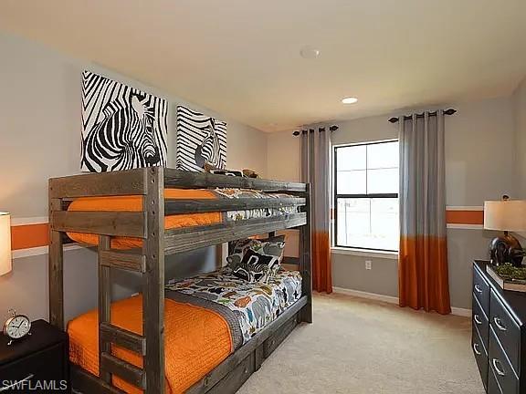 4085 Spotted Eagle Way Fort Myers, FL 33966 - Photo 8 of 12 a bedroom with a bed and a window