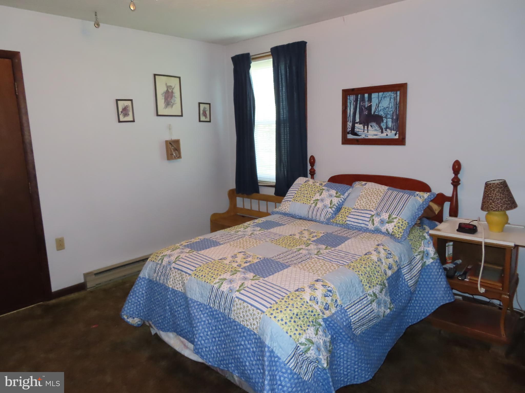 3338 Centennial Road Hanover, PA 17331 - Photo 15 of 30 a bedroom with a bed and painting on the wall