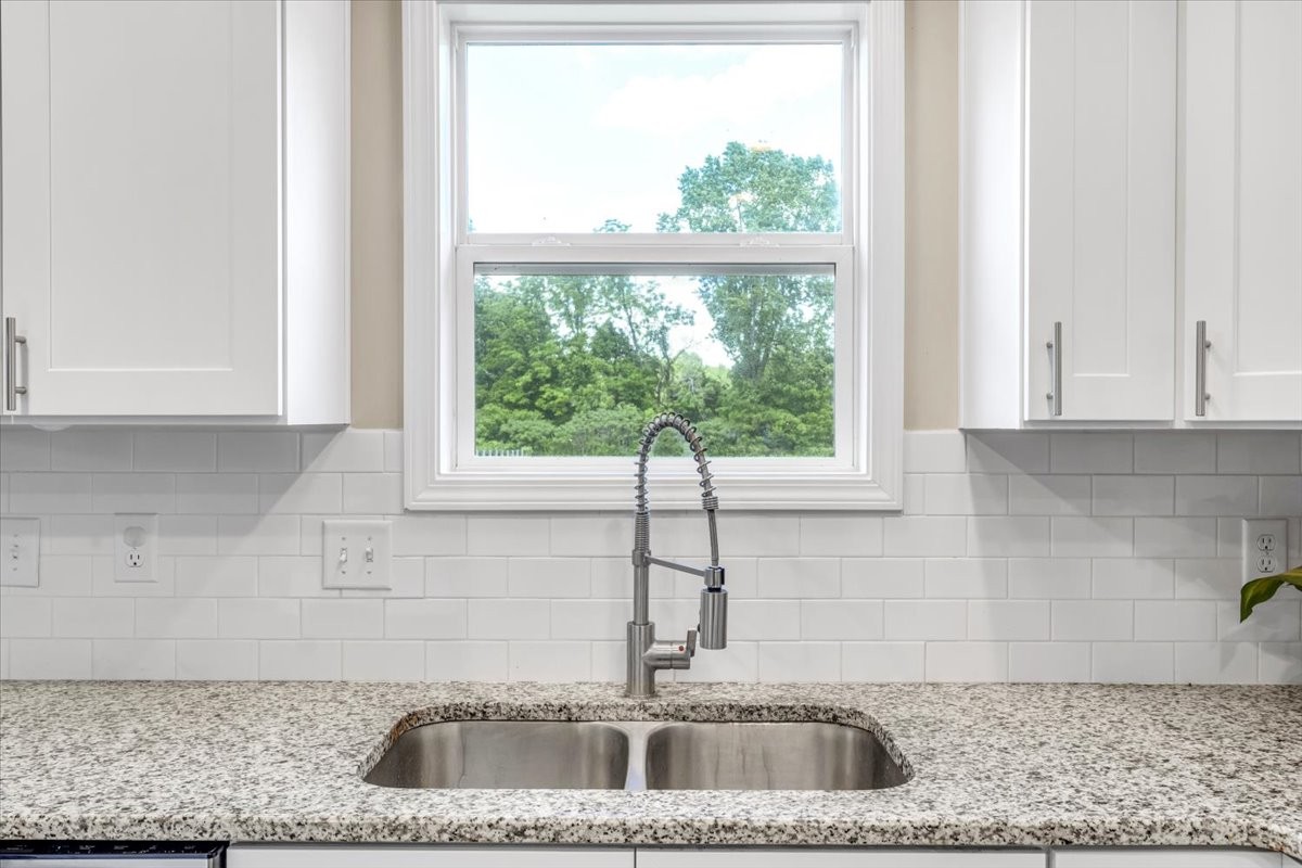 147 Ray Jent Road Bethpage, TN 37022 - Photo 16 of 47 a kitchen with granite countertop a sink and a window