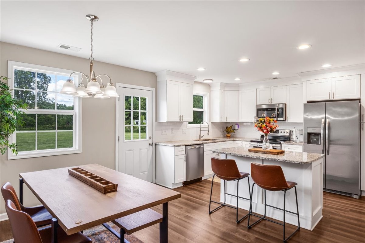 147 Ray Jent Road Bethpage, TN 37022 - Photo 22 of 47 a kitchen with refrigerator cabinets dining table and chairs