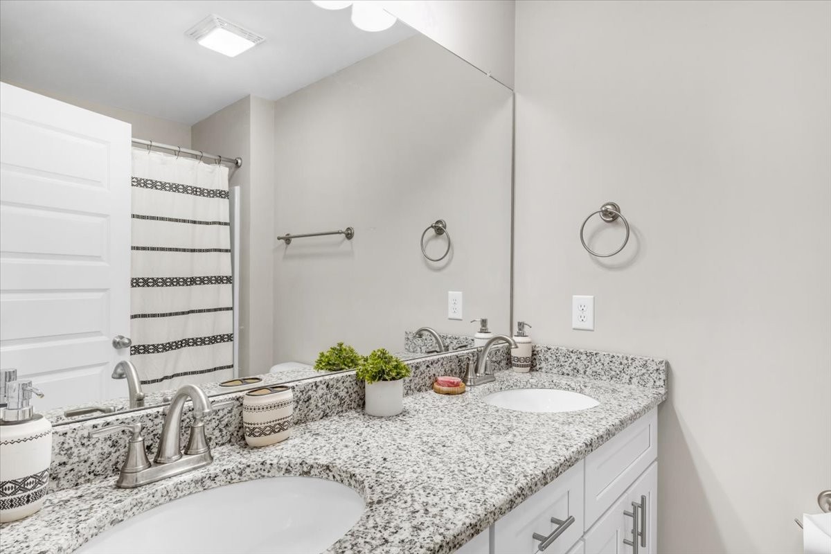 147 Ray Jent Road Bethpage, TN 37022 - Photo 25 of 47 a bathroom with a granite countertop sink and a mirror