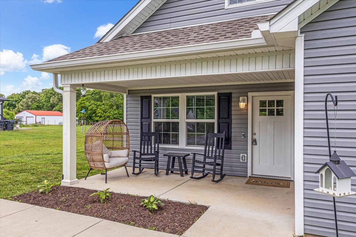 147 Ray Jent Road Bethpage, TN 37022 - Photo 3 of 47 a front view of a house with a chairs and table in patio