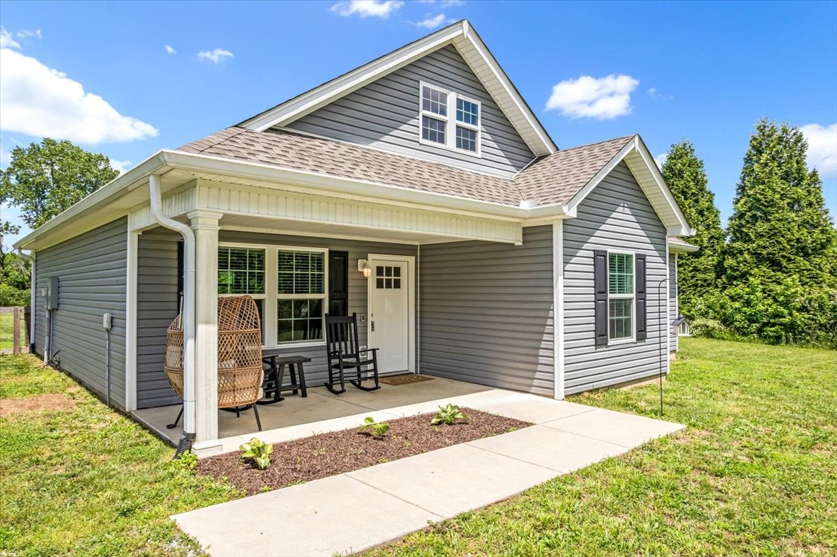 147 Ray Jent Road Bethpage, TN 37022 - Photo 9 of 47 a front view of a house with a garden and patio