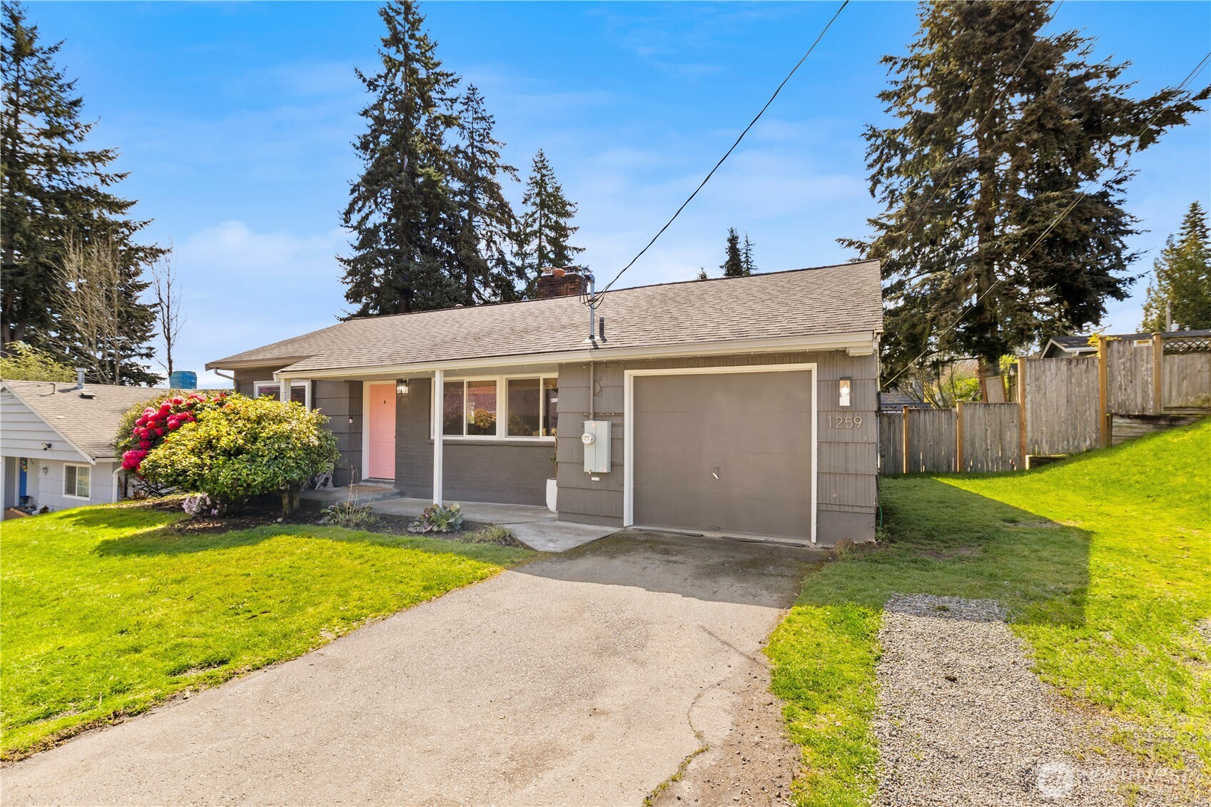 1259 North 173rd Street Shoreline, WA 98133 - Photo 1 of 37 a front view of house with yard and green space