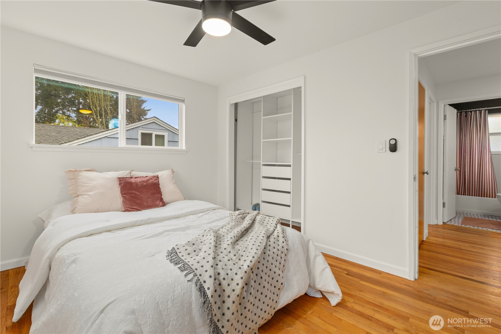1259 North 173rd Street Shoreline, WA 98133 - Photo 21 of 37 a bedroom with a bed and wooden floor