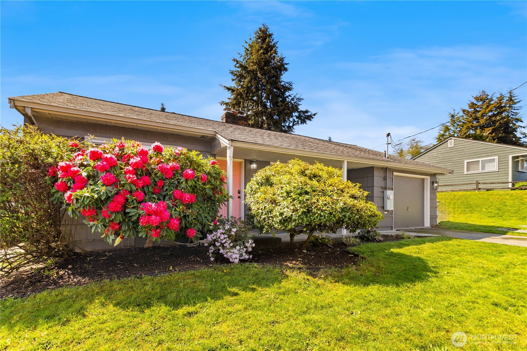 1259 North 173rd Street Shoreline, WA 98133 - Photo 35 of 37 a front view of house with garden and flowers