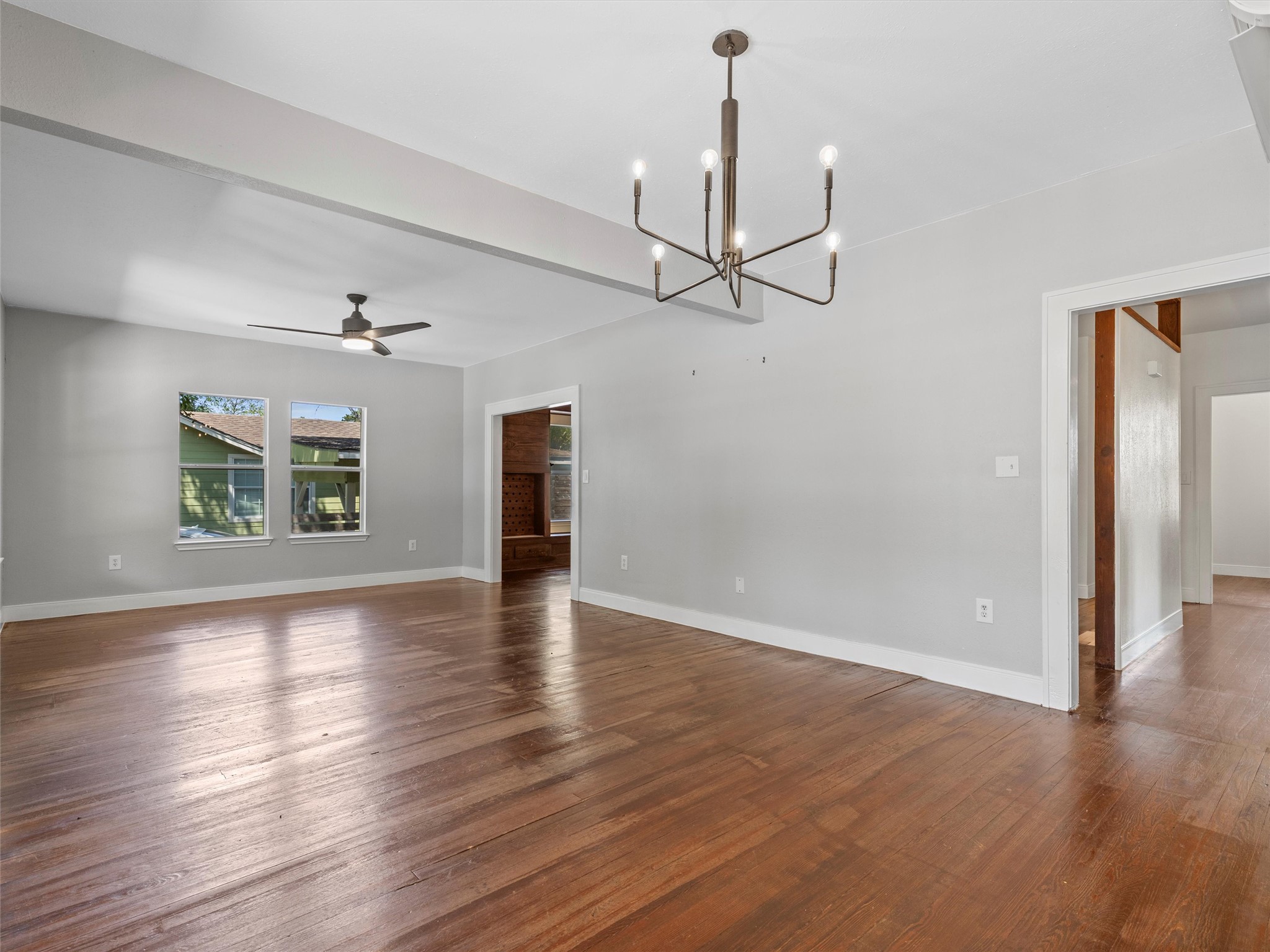 1809 Wilson Street Bastrop, TX 78602 - Photo 11 of 40 a view of an empty room with wooden floor ceiling fan