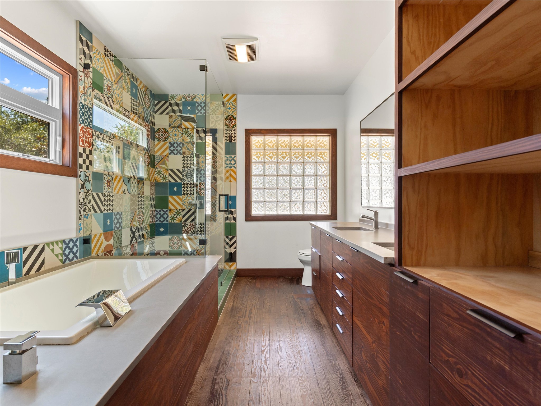 1809 Wilson Street Bastrop, TX 78602 - Photo 27 of 40 a bathroom with a granite countertop tub sink and mirror