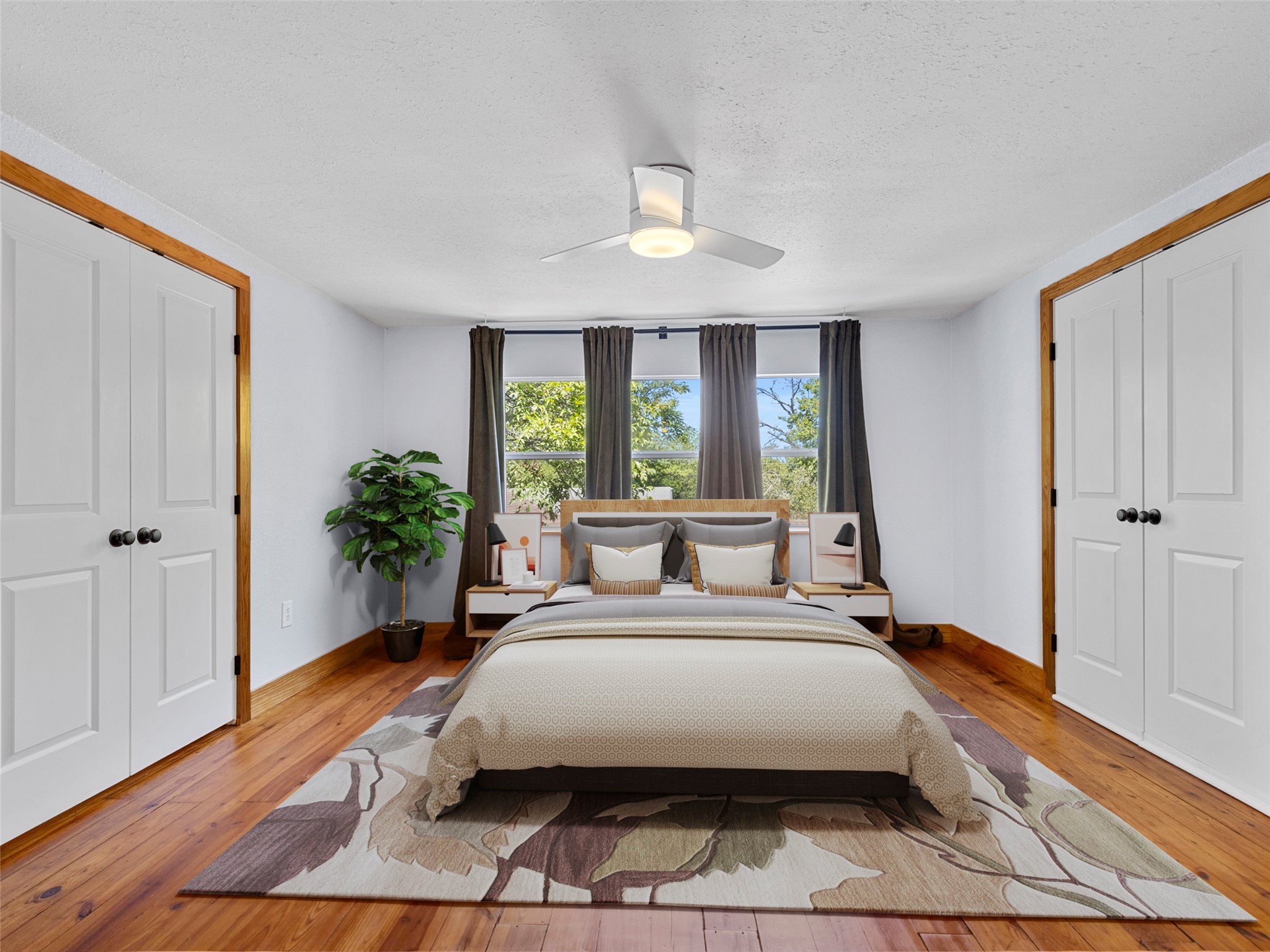 1809 Wilson Street Bastrop, TX 78602 - Photo 29 of 40 a spacious bedroom with a large bed a chandelier and windows