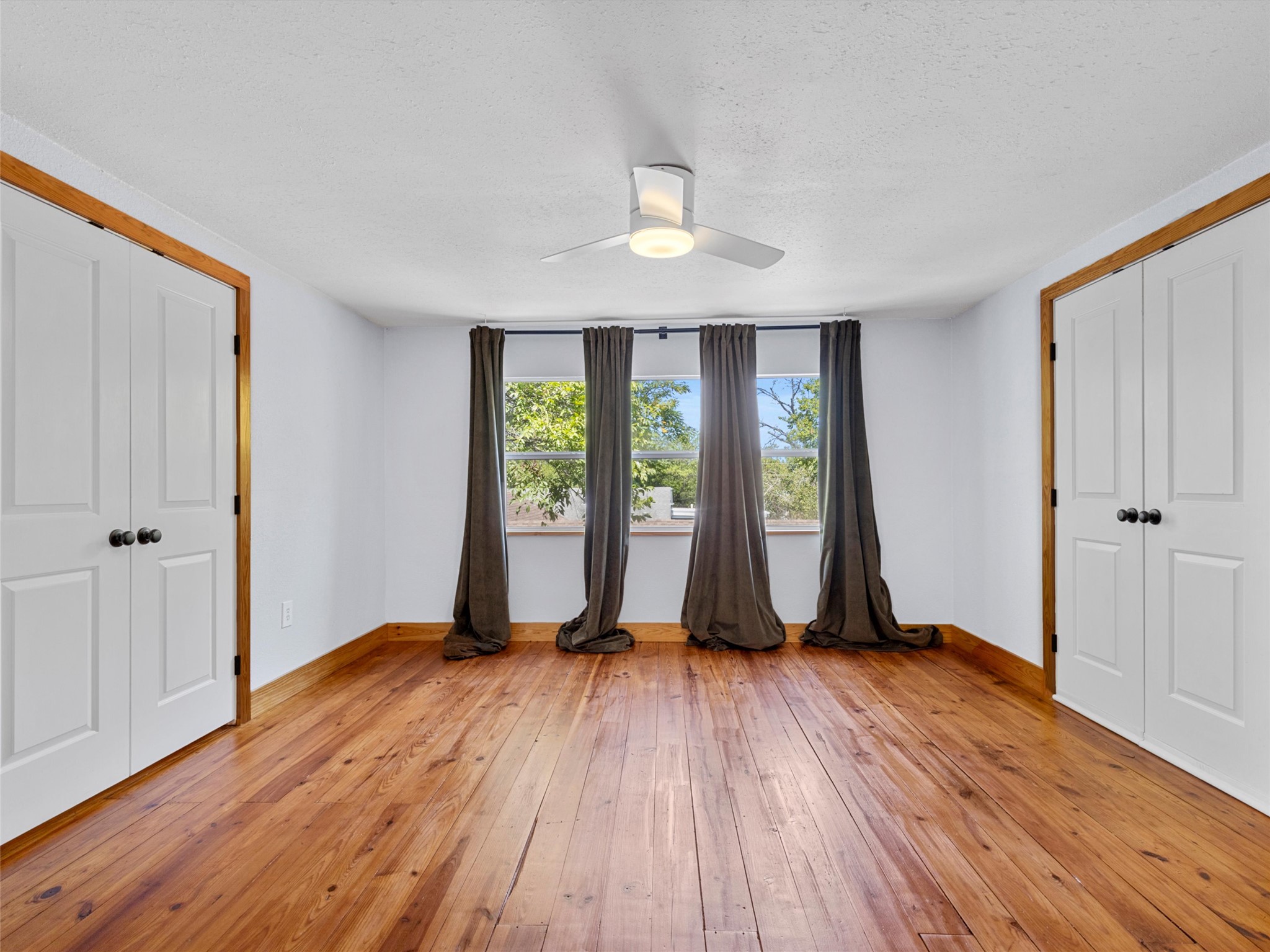 1809 Wilson Street Bastrop, TX 78602 - Photo 30 of 40 an empty room with wooden floor and windows