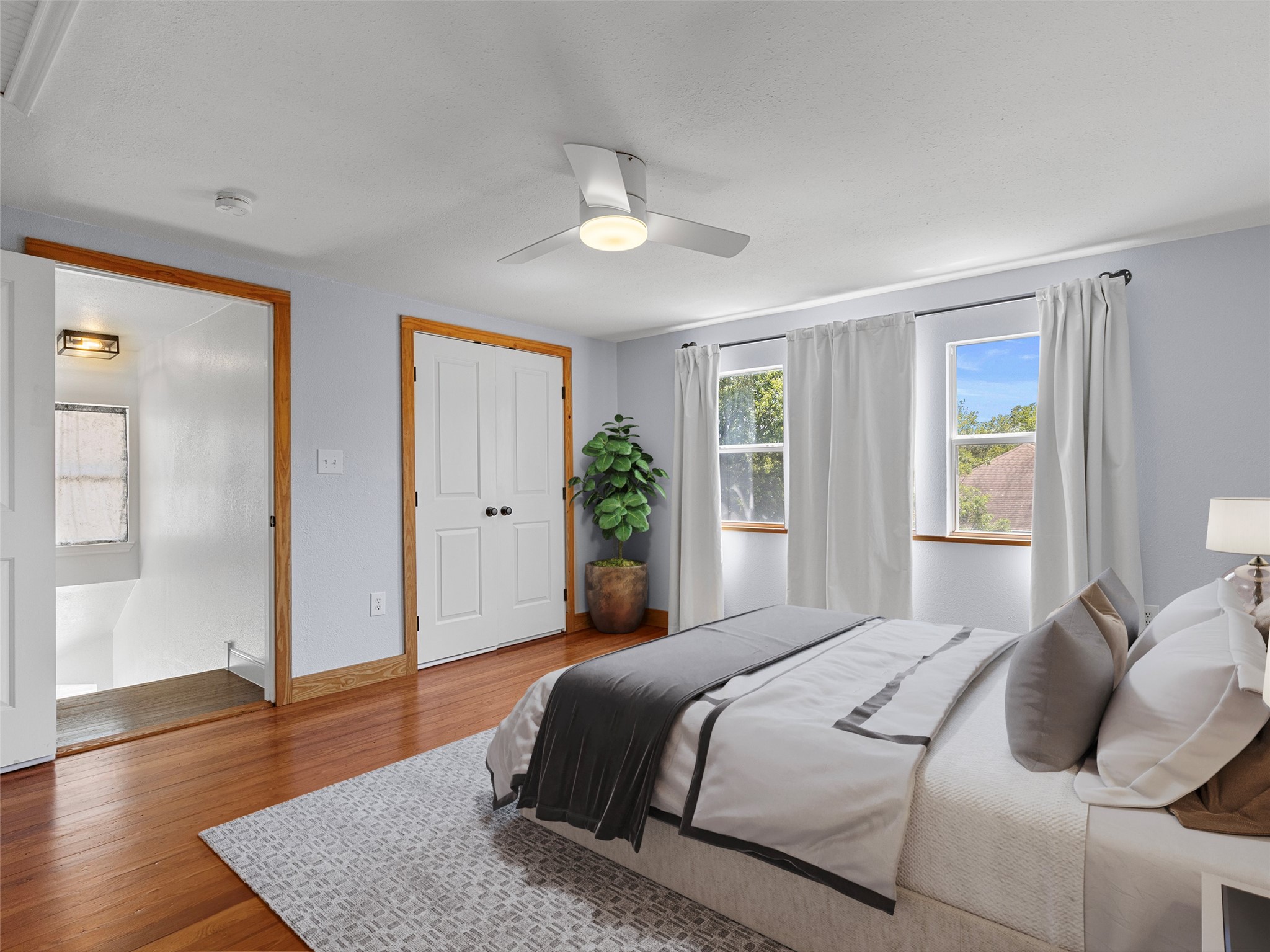 1809 Wilson Street Bastrop, TX 78602 - Photo 32 of 40 a bedroom with a large bed and a wooden floor