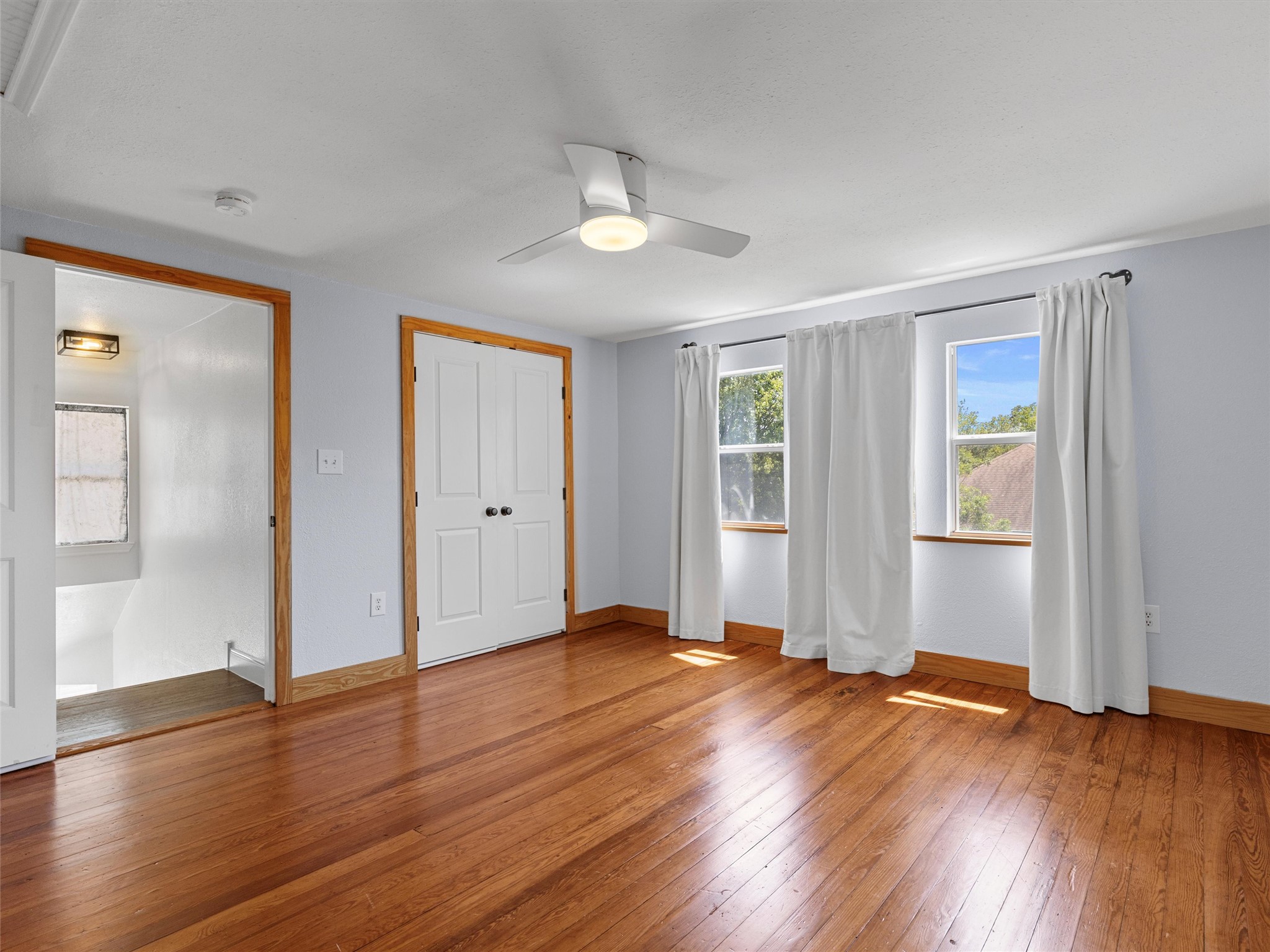 1809 Wilson Street Bastrop, TX 78602 - Photo 33 of 40 an empty room with wooden floor and windows