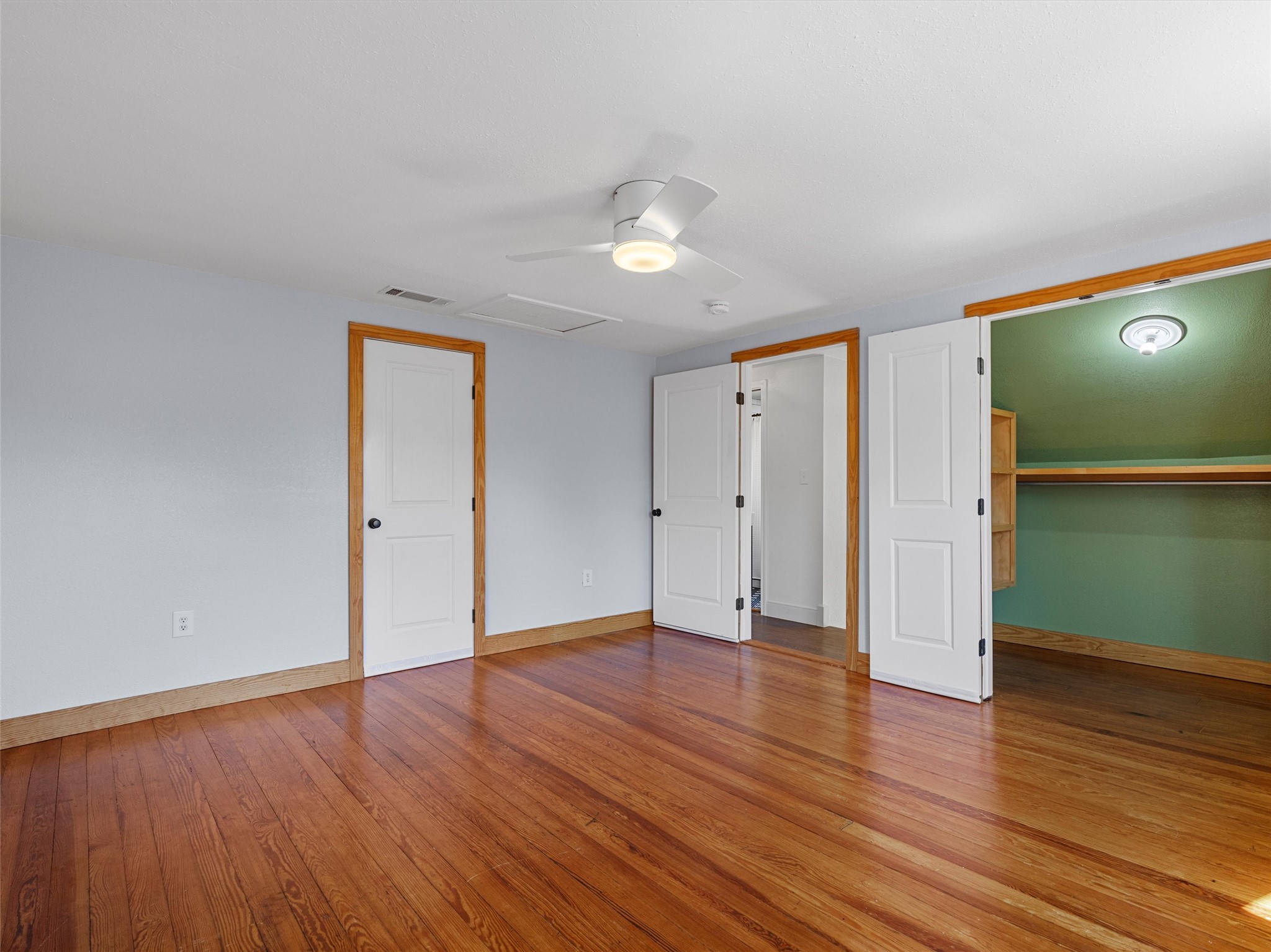 1809 Wilson Street Bastrop, TX 78602 - Photo 34 of 40 an empty room with wooden floor and mirror