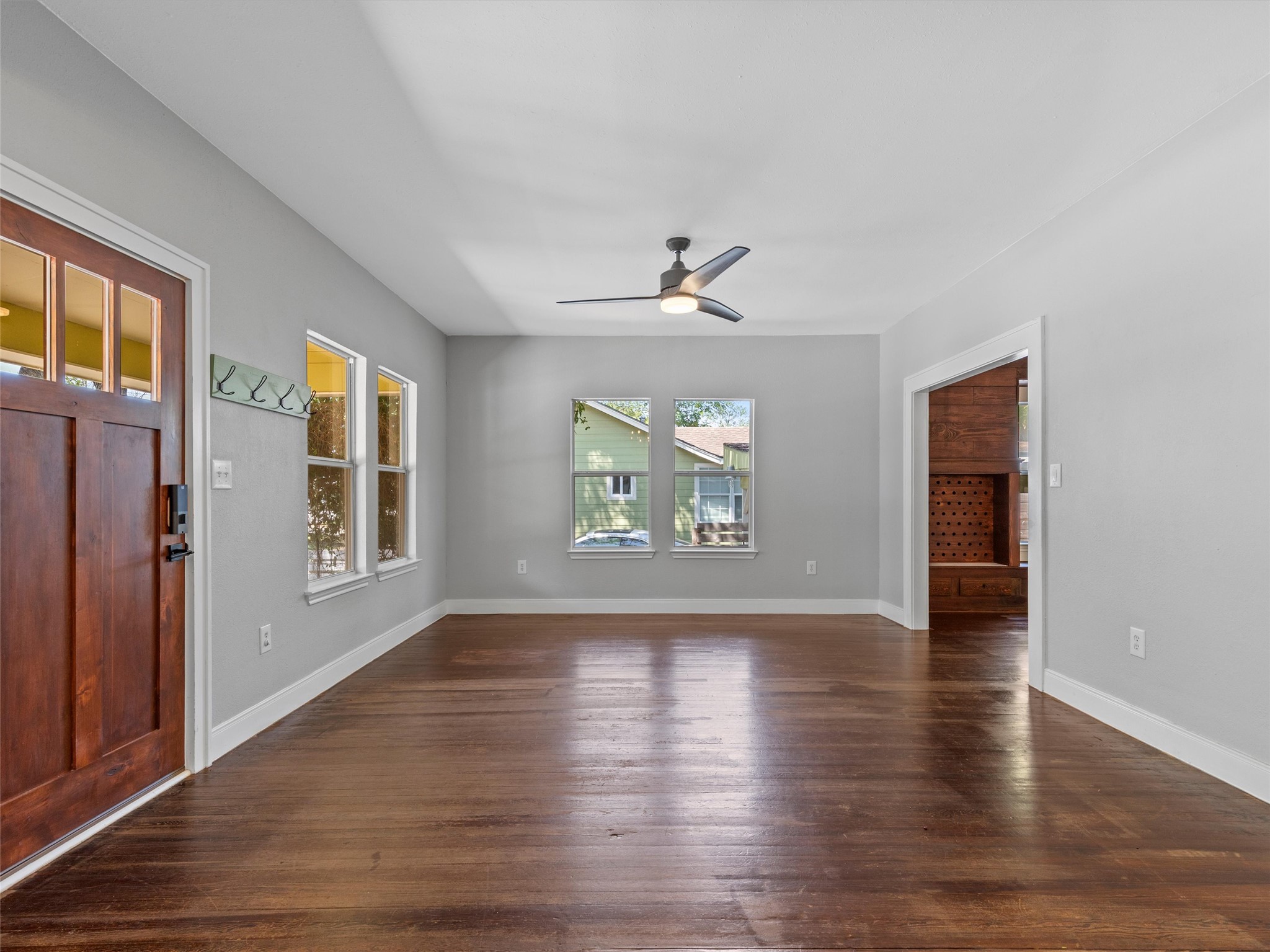 1809 Wilson Street Bastrop, TX 78602 - Photo 5 of 40 a view of an empty room with wooden floor and a window