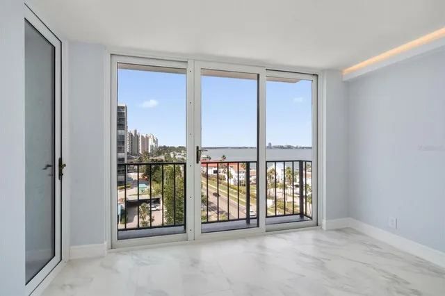 an empty room with windows and city view