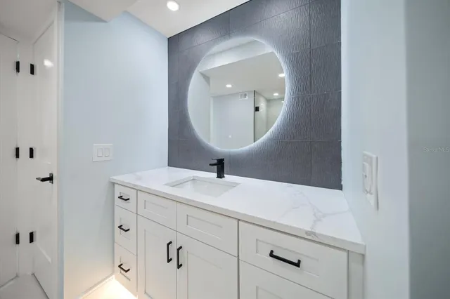 a bathroom with a sink and a mirror