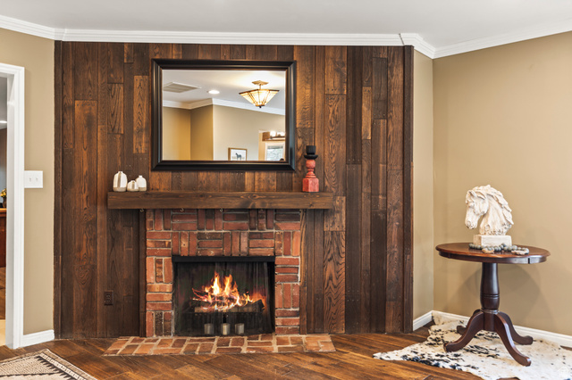 460 Omni Point Road Central Valley, UT 84754 - Photo 21 of 101 Brick fireplace with a substantial wood mantel, framed by a full wood-paneled accent wall