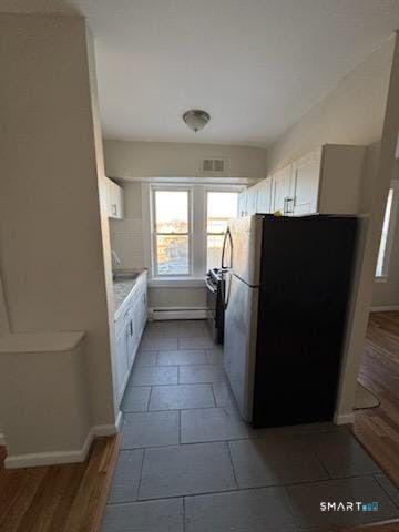 335 Wells Street, Unit 11 Bridgeport, CT 06606 - Photo 1 of 4 a kitchen with a refrigerator and window