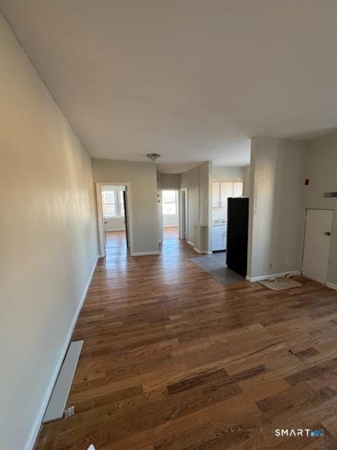 335 Wells Street, Unit 11 Bridgeport, CT 06606 - Photo 2 of 4 a view of an empty room with wooden floor and a window