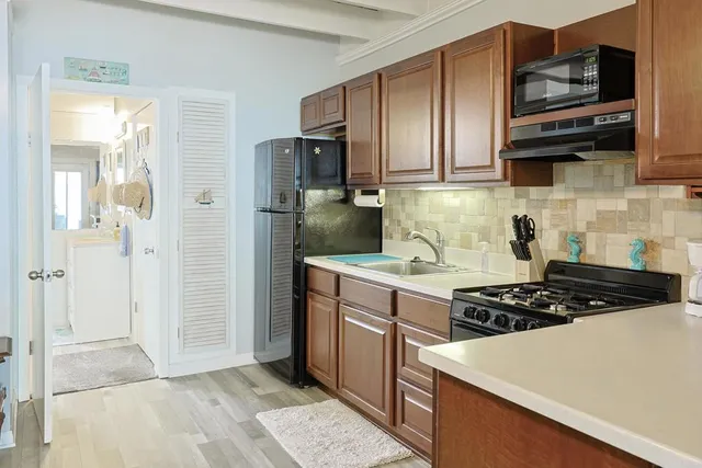 a kitchen with stainless steel appliances granite countertop a stove a refrigerator and a microwave