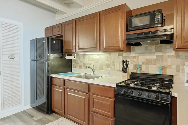 a kitchen with stainless steel appliances granite countertop a stove microwave and refrigerator