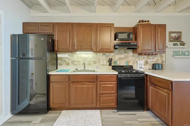 a kitchen with stainless steel appliances granite countertop a refrigerator stove and sink