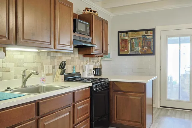 a kitchen with stainless steel appliances granite countertop a sink stove and cabinets