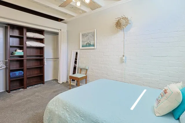 a bedroom with a bed and a book shelf