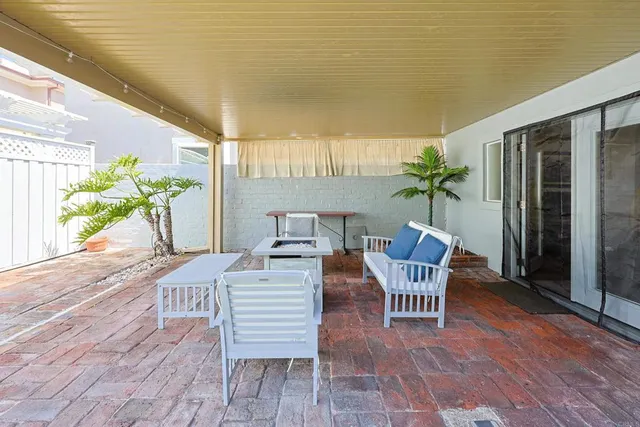 a view of a dining room with furniture and a potted plant