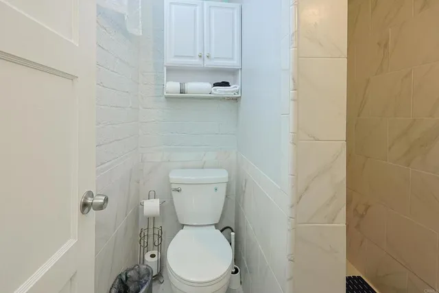 a white toilet sitting next to a white sink