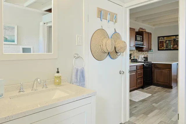 a kitchen with a sink cabinets and a wooden floor