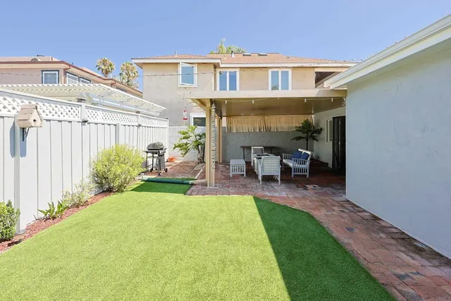 a front view of a house with garden and patio